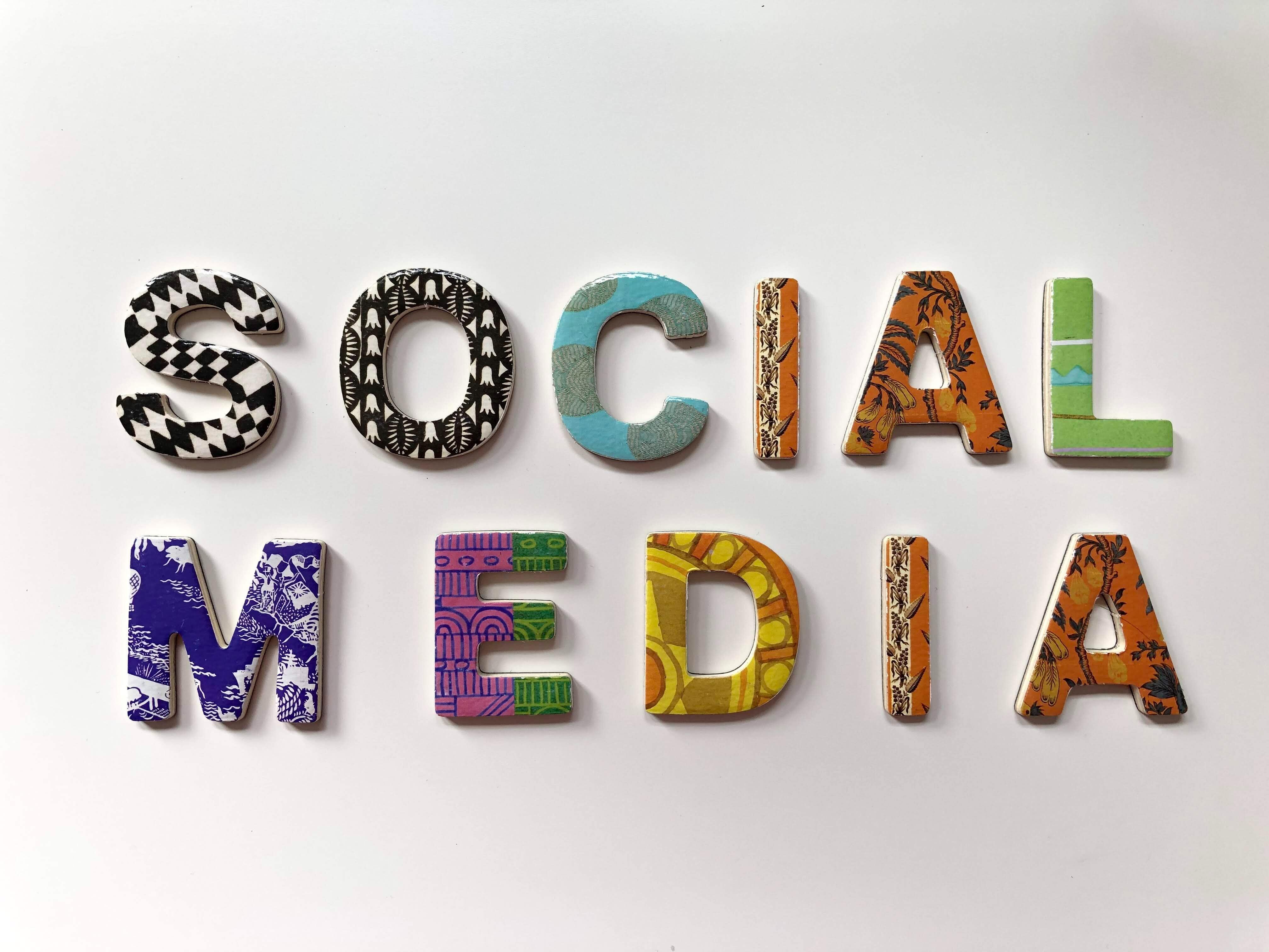 social media written on white wall in colourful letters