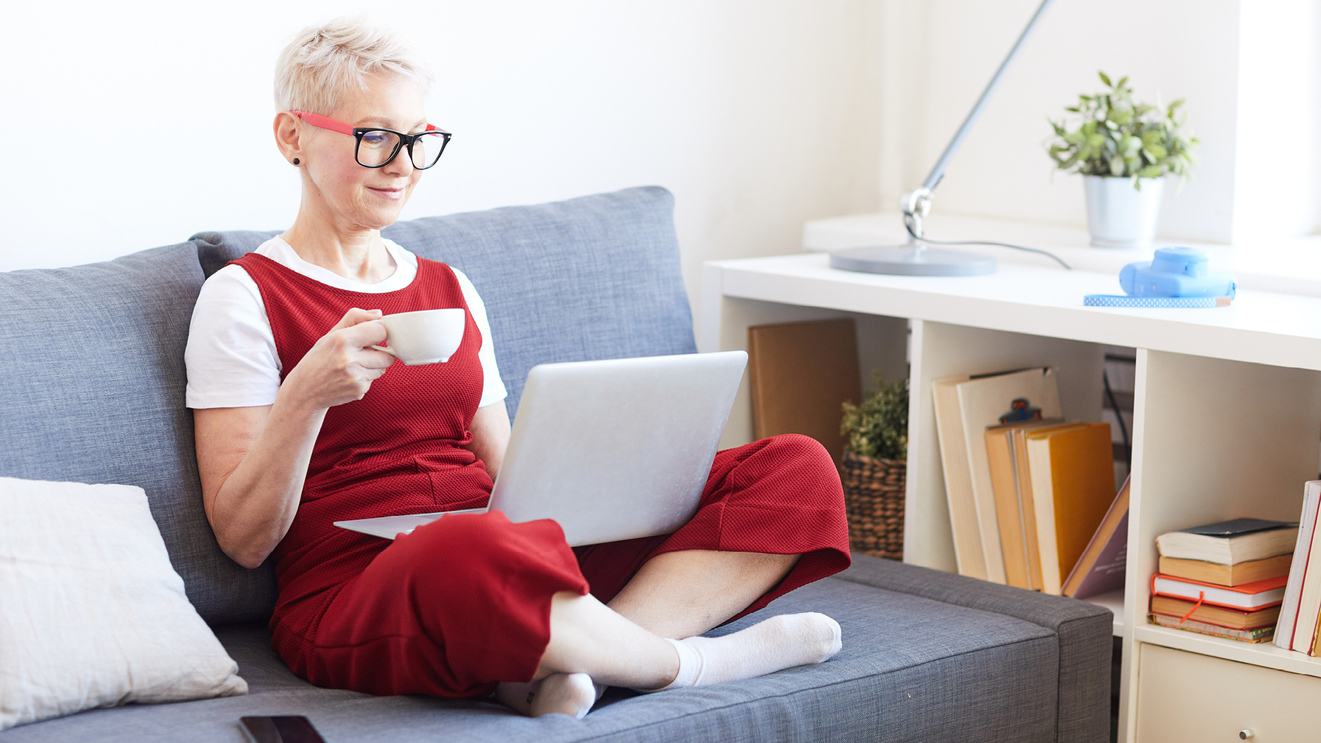 woman on couch looking at laptop