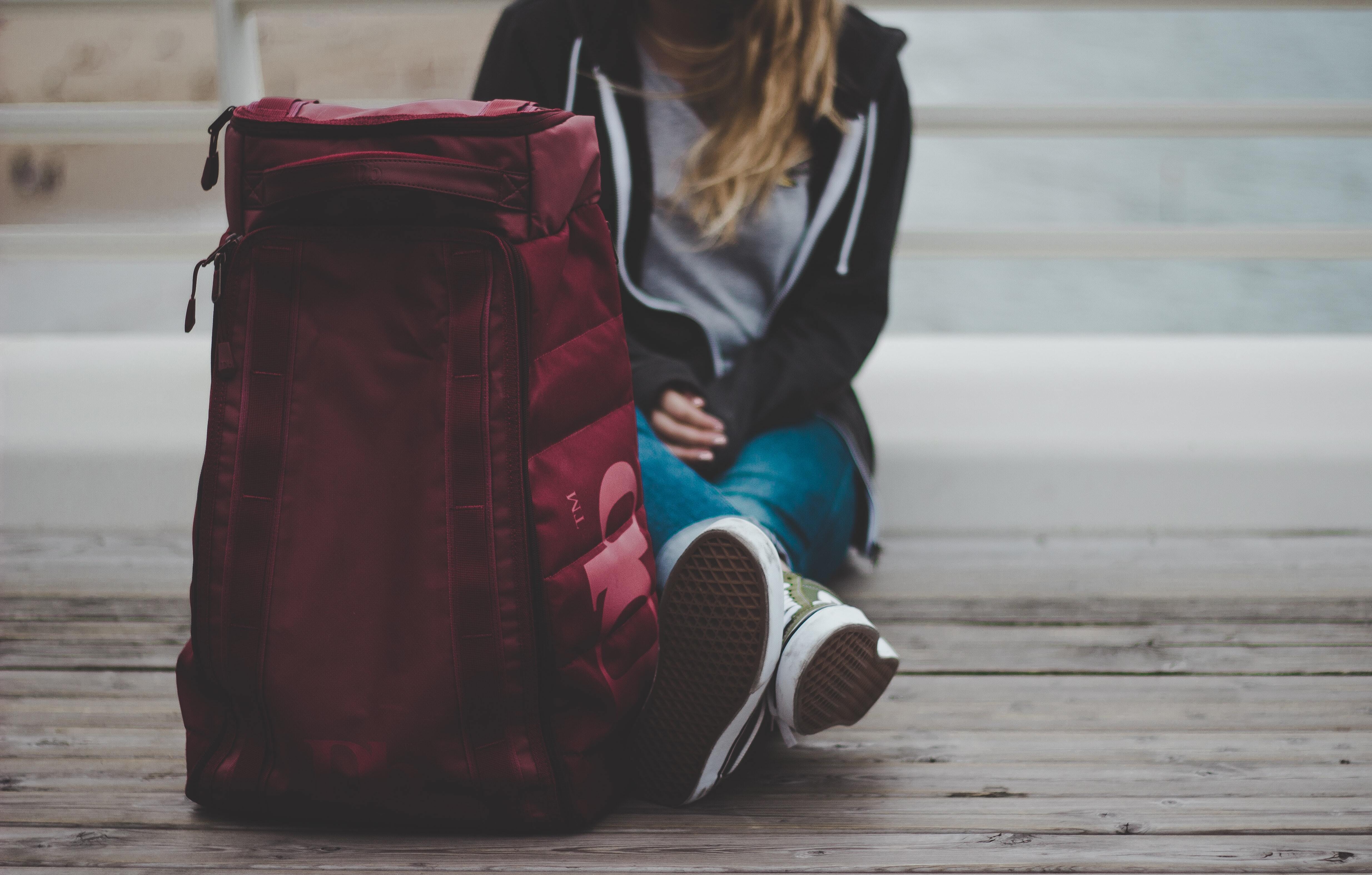girl sitting with red backpack